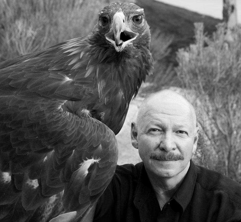 Dr. Charles "Chuck" Preston, '72, with a 金 eagle in Greater Yellowstone